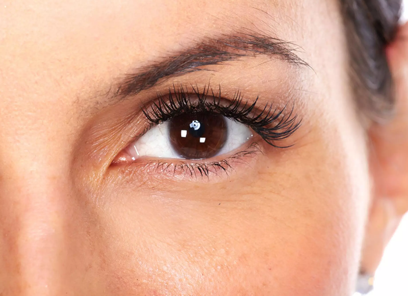 Imagem de uma mulher branca com o foco em um de seus olhos.